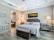Elegant main bedroom with comfortable bed, stylish furnishings, and access to bath at 1958 Marshberry Ct, Trinity, FL 34655