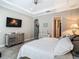 Comfortable main bedroom with stylish decor, ceiling fan, and en-suite access at 1958 Marshberry Ct, Trinity, FL 34655
