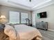Spacious main bedroom with tray ceiling, tile floors, and views of the backyard at 1958 Marshberry Ct, Trinity, FL 34655