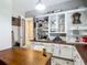 View of the home office with custom built-in shelving and a wooden desktop at 1958 Marshberry Ct, Trinity, FL 34655