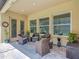 Inviting outdoor patio space with wicker seating, a rug, and view of natural landscape at 1958 Marshberry Ct, Trinity, FL 34655
