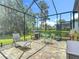 Screened patio with lounge chairs, BBQ, table and chairs for outdoor enjoyment at 1958 Marshberry Ct, Trinity, FL 34655