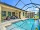 Beautiful in-ground pool with patio area and lush green lawn views at 1958 Marshberry Ct, Trinity, FL 34655