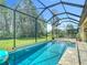 Screened pool area with outdoor kitchen, and seating area at 1958 Marshberry Ct, Trinity, FL 34655