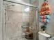Modern shower area features glass enclosure, coordinated towels, and neutral tiling at 1958 Marshberry Ct, Trinity, FL 34655