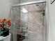 Walk-in shower featuring neutral colored tile, glass doors, rain shower head, and built in bench at 1958 Marshberry Ct, Trinity, FL 34655