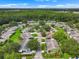 Aerial view featuring a residential community nestled among lush greenery and trees, offering a serene and picturesque setting at 2006 Hadrian Ct, Sun City Center, FL 33573