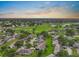 Scenic aerial view of a vibrant residential community with lush green spaces and a serene pond at 2006 Hadrian Ct, Sun City Center, FL 33573