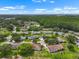Aerial view featuring a residential community nestled among lush greenery and trees, offering a serene and picturesque setting at 2006 Hadrian Ct, Sun City Center, FL 33573