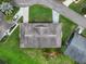 Aerial view displays the home's roof and backyard alongside manicured lawns and neighborhood streets, offering a bird's-eye perspective at 2006 Hadrian Ct, Sun City Center, FL 33573