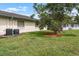 Landscaped backyard features a well-maintained lawn and view of house, creating a serene and inviting outdoor space at 2006 Hadrian Ct, Sun City Center, FL 33573
