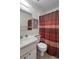 Cozy bathroom with patterned wallpaper, classic fixtures, and a warm-toned shower curtain at 2006 Hadrian Ct, Sun City Center, FL 33573