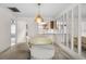 Open dining area with modern lighting fixture and adjacent kitchen view at 2006 Hadrian Ct, Sun City Center, FL 33573