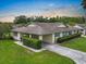 Charming single-story home featuring a well-maintained lawn, carport, and mature landscaping at 2006 Hadrian Ct, Sun City Center, FL 33573