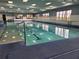 Bright indoor pool featuring large windows, marked swim lanes, and clear, inviting water at 2006 Hadrian Ct, Sun City Center, FL 33573