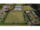 Aerial view of community lawn bowling area with players in action, along with golf carts and parked cars at 2006 Hadrian Ct, Sun City Center, FL 33573
