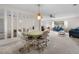 Bright living room featuring neutral carpet, comfortable seating, and mirrored wall accents at 2006 Hadrian Ct, Sun City Center, FL 33573
