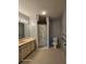 This bathroom has a neutral vanity with a decorative wallpaper and enclosed shower at 2221 Norwegian Dr # 15, Clearwater, FL 33763