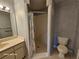 This bathroom has a neutral vanity with a decorative wallpaper and enclosed shower at 2221 Norwegian Dr # 15, Clearwater, FL 33763