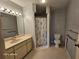 This bathroom has a neutral vanity with a decorative wallpaper and enclosed shower at 2221 Norwegian Dr # 15, Clearwater, FL 33763