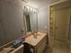 Bathroom featuring a vanity sink, toilet, and doorway to closet space at 2221 Norwegian Dr # 15, Clearwater, FL 33763