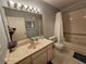 Bathroom with a vanity sink, toilet, and bathtub-shower combination with shower curtain at 2221 Norwegian Dr # 15, Clearwater, FL 33763