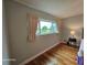 Bedroom with hardwood flooring, bright window, and comfortable decor at 2221 Norwegian Dr # 15, Clearwater, FL 33763