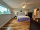 Comfortable bedroom with hardwood flooring, large window, and ensuite bathroom access at 2221 Norwegian Dr # 15, Clearwater, FL 33763