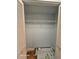 Open closet with white shelving and bifold doors on a hard wood floor at 2221 Norwegian Dr # 15, Clearwater, FL 33763