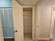 Hallway with a linen closet featuring open shelving for storage and a utility box at 2221 Norwegian Dr # 15, Clearwater, FL 33763