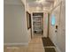 Hallway showing closet with storage shelves, door, and decorative mirror at 2221 Norwegian Dr # 15, Clearwater, FL 33763