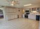 Bright kitchen with tile flooring, light cabinetry, and stainless steel appliances at 2221 Norwegian Dr # 15, Clearwater, FL 33763