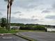 Scenic view of the community lake, lush landscaping, and parking area at 2221 Norwegian Dr # 15, Clearwater, FL 33763