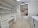 Functional laundry room featuring tile flooring, storage shelves, and modern washer and dryer at 2221 Norwegian Dr # 15, Clearwater, FL 33763