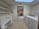 Cozy laundry room with tile flooring, storage shelves, and modern washer and dryer at 2221 Norwegian Dr # 15, Clearwater, FL 33763