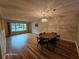 Well-lit living room with hardwood floors, dining area and a window at 2221 Norwegian Dr # 15, Clearwater, FL 33763