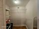 A walk-in closet with wire shelving, hard wood floor, and bifold doors at 2221 Norwegian Dr # 15, Clearwater, FL 33763