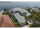 Aerial view of a luxurious waterfront estate with a circular driveway and manicured lawn at 2279 Mermaid Ne Pt, St Petersburg, FL 33703