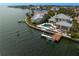 Waterfront home with dock, and pool featuring lush landscaping by the water at 2279 Mermaid Ne Pt, St Petersburg, FL 33703