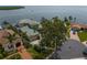 Aerial view of luxury estate on a waterfront lot with lush landscaping and a circular driveway at 2279 Mermaid Ne Pt, St Petersburg, FL 33703