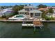 Aerial view of waterfront home featuring a large pool, dock, and lush landscaping at 2279 Mermaid Ne Pt, St Petersburg, FL 33703