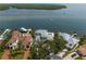 An aerial view of the waterfront estate with boat dock and lush green trees and lawn at 2279 Mermaid Ne Pt, St Petersburg, FL 33703