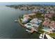 Waterfront property featuring boat dock, pool, and luxurious landscaping on a sunny day at 2279 Mermaid Ne Pt, St Petersburg, FL 33703