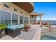 Back patio showcasing an outdoor kitchen and comfortable outdoor furniture with water view at 2279 Mermaid Ne Pt, St Petersburg, FL 33703