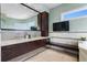 Bathroom with glass vessel sinks, dark wood cabinetry, and large mirror at 2279 Mermaid Ne Pt, St Petersburg, FL 33703