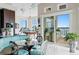 Bright dining area with modern furniture, water view, pool table, and sliding glass door to the outdoors at 2279 Mermaid Ne Pt, St Petersburg, FL 33703