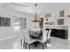 Bright dining room features modern light fixture, built-in display shelves, and an elegant marble floor at 2279 Mermaid Ne Pt, St Petersburg, FL 33703