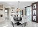 Elegant dining room featuring a large table, modern chandelier, and unique architectural details at 2279 Mermaid Ne Pt, St Petersburg, FL 33703