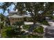 Beautiful exterior of home featuring a lush tropical landscaped yard with mature trees at 2279 Mermaid Ne Pt, St Petersburg, FL 33703