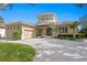 Elegant two-story home with a circular tower, manicured landscaping, and a spacious driveway at 2279 Mermaid Ne Pt, St Petersburg, FL 33703